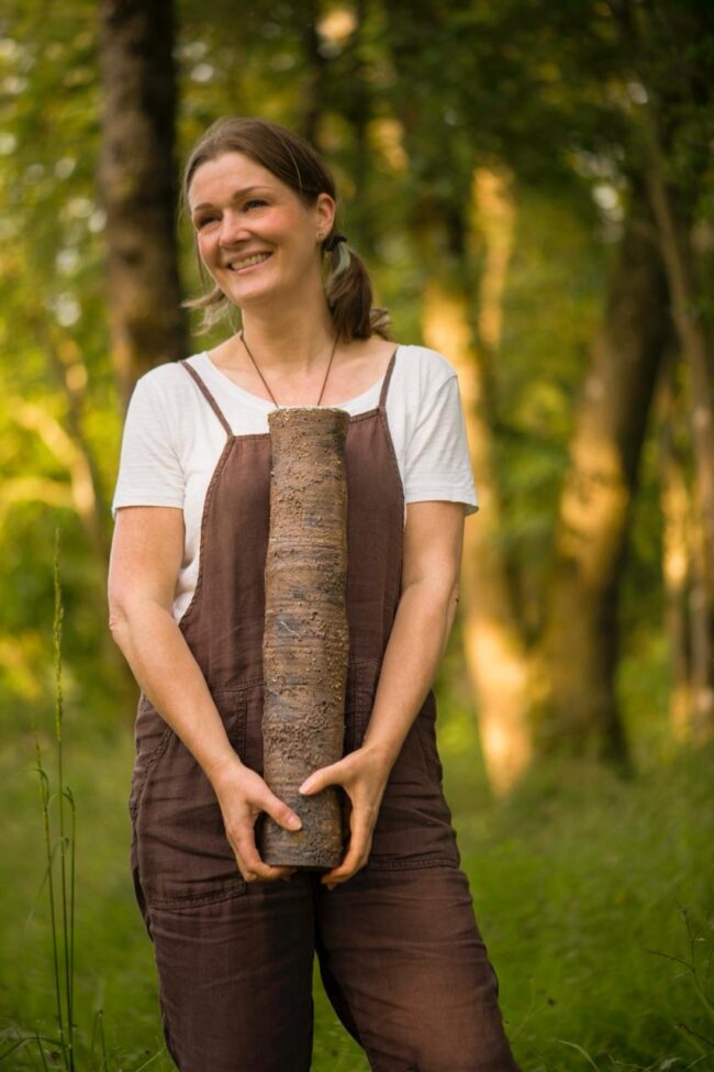 Sonya Wilkins Holding Ceramic Tree Trunk Vessel in Hutton Woodland