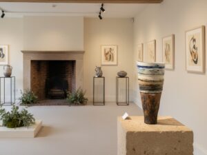 Layered Ceramic Landscape Vessel on a plinth within a gallery setting